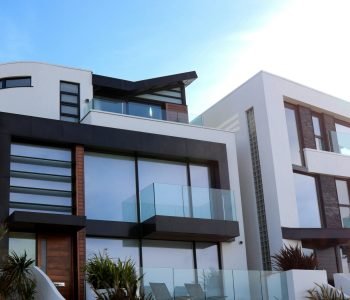 Contemporary luxury home with glass balconies in Poole, UK, showcasing modern architectural design.